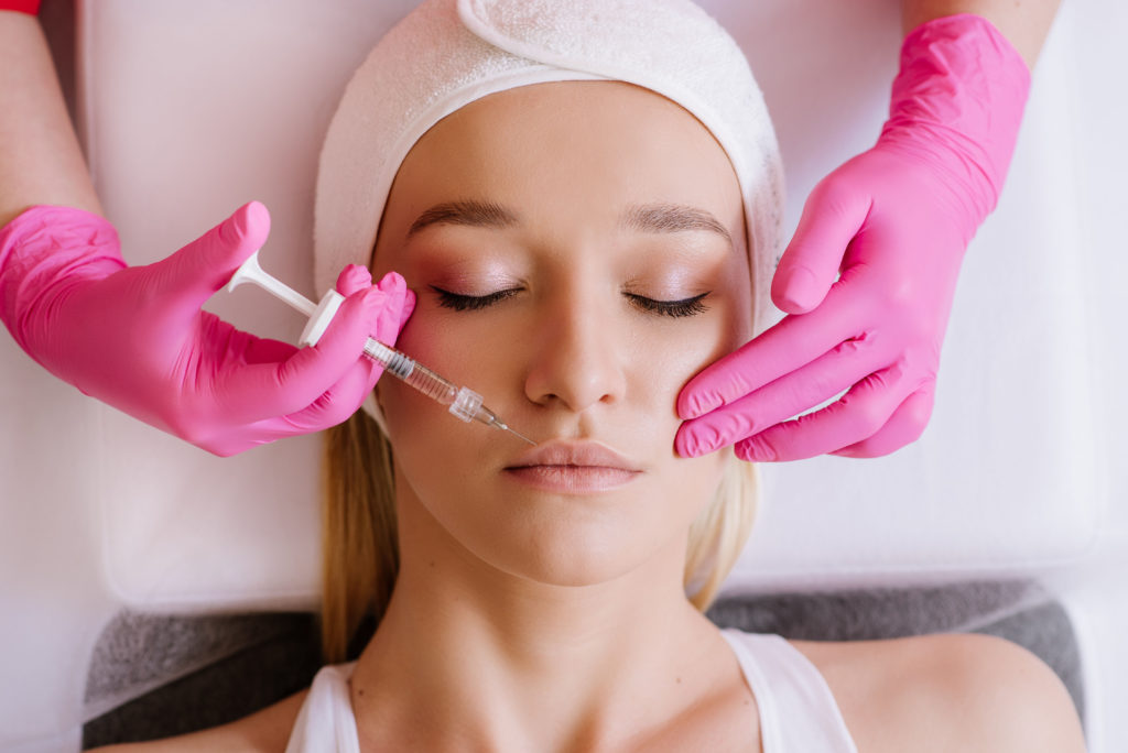 Contour plasticity of lips, augmentation of lips, introduction of filler of hyaluronic acid on woman in SPA center | Thrive Wellness in Cummings Hwy, Chattanooga, TN