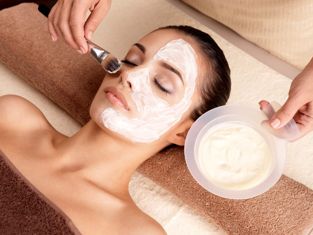 Spa therapy for young woman receiving facial mask at beauty salon - indoors | Thrive Wellness in Cummings Hwy, Chattanooga, TN