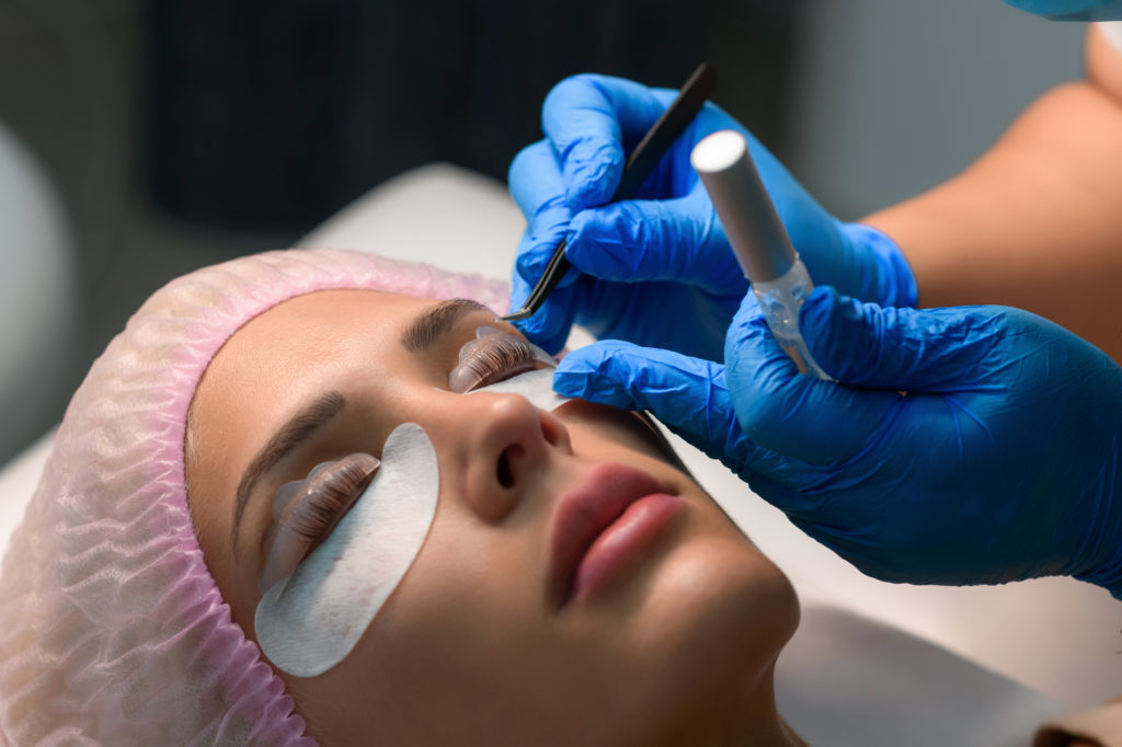 Eyelash care treatment procedures. Woman doing eyelashes lamination, staining, curling, laminating and extension for lashes | Thrive Wellness in Cummings Hwy, Chattanooga, TN